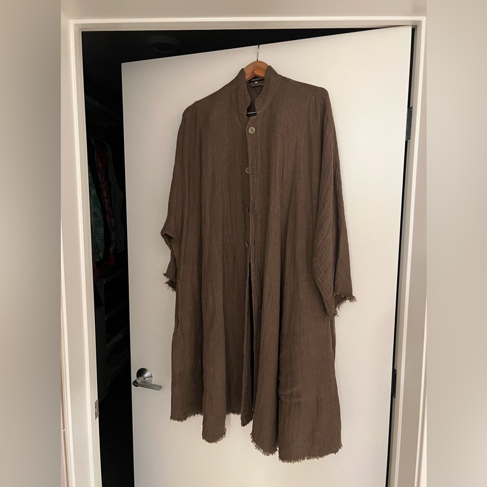 Eskandar coat with raw hem.